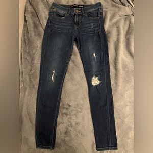 Express blue wash jean. Ankle skinny, mid-rise, rips in the front. Size 0.